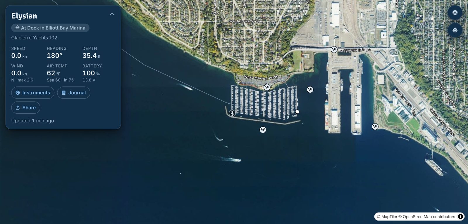The Saillogger chart: the boat's live status card reading At Dock in Elliott Bay Marina, with speed, heading, depth, wind and battery readings over a satellite view of the marina